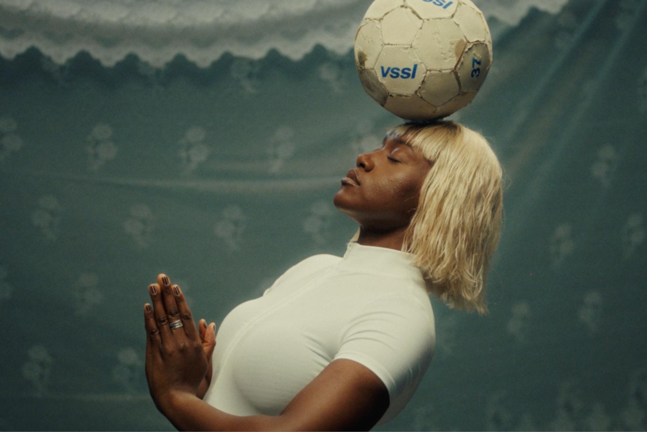 Woman balancing a football on her head