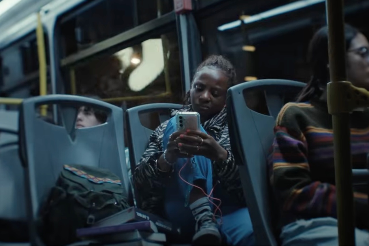 woman on the bus looking at her phone