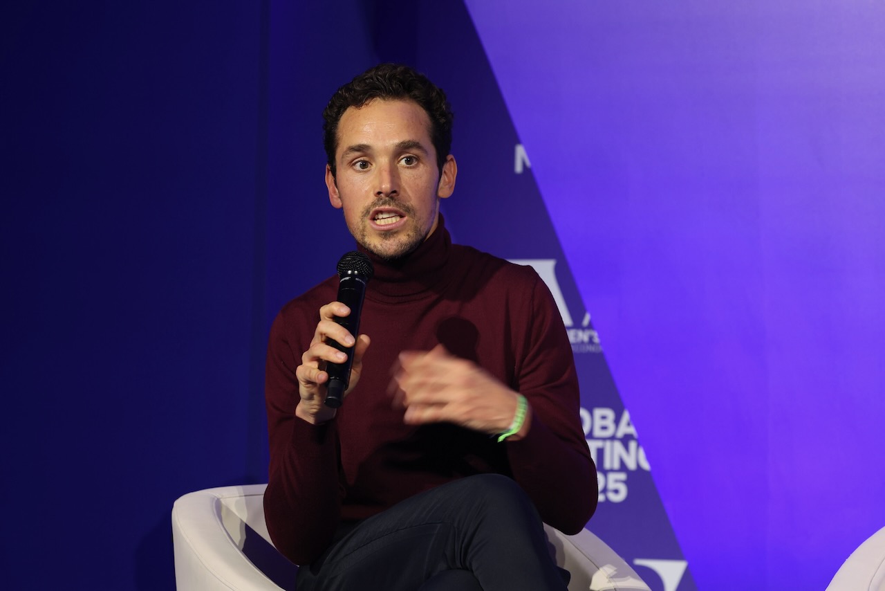Fabien Paget speaking into a mic at an event