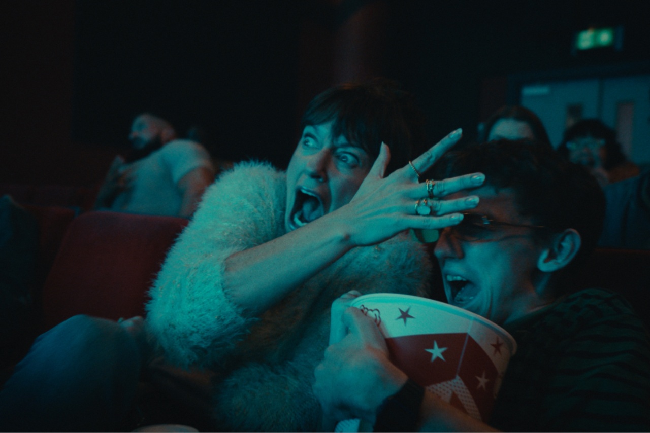 Woman screaming in cinema screen