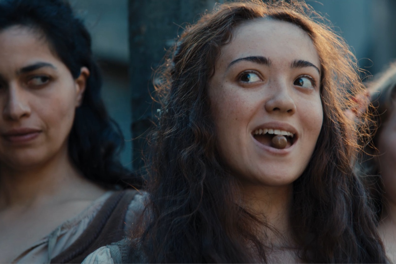 Woman holding Malteser in her mouth