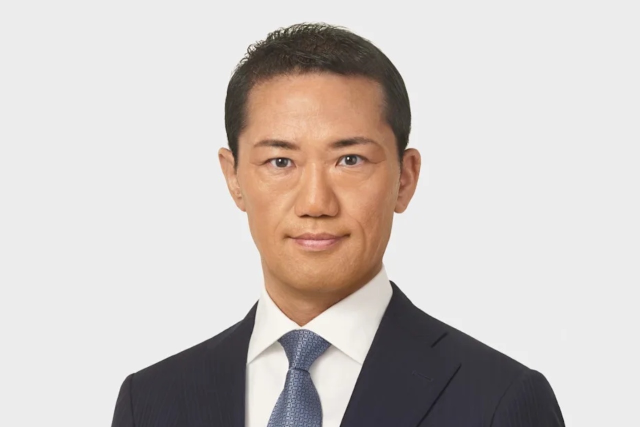 Takeshi Sano wearing a suit and tie