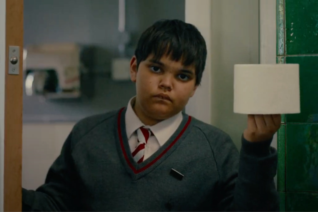 School boy holding toilet roll