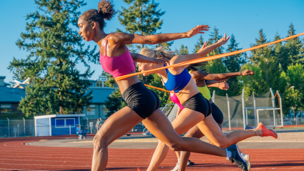 Image of female sprinters crossing the finishing line