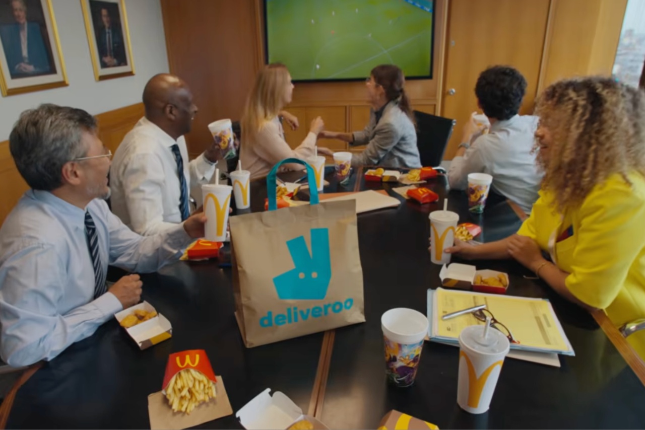 People in the office with Deliveroo watching the football