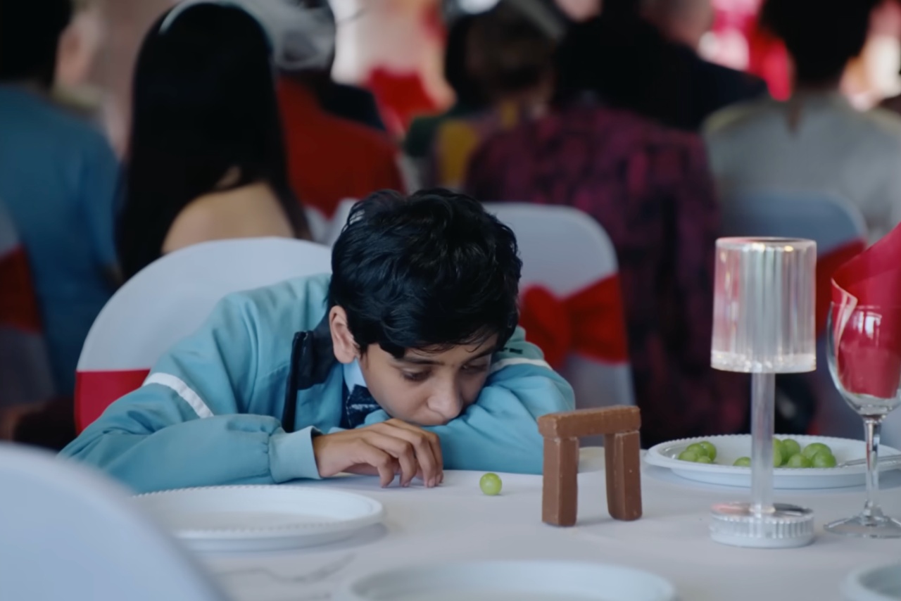 Boy sitting at a wedding table 