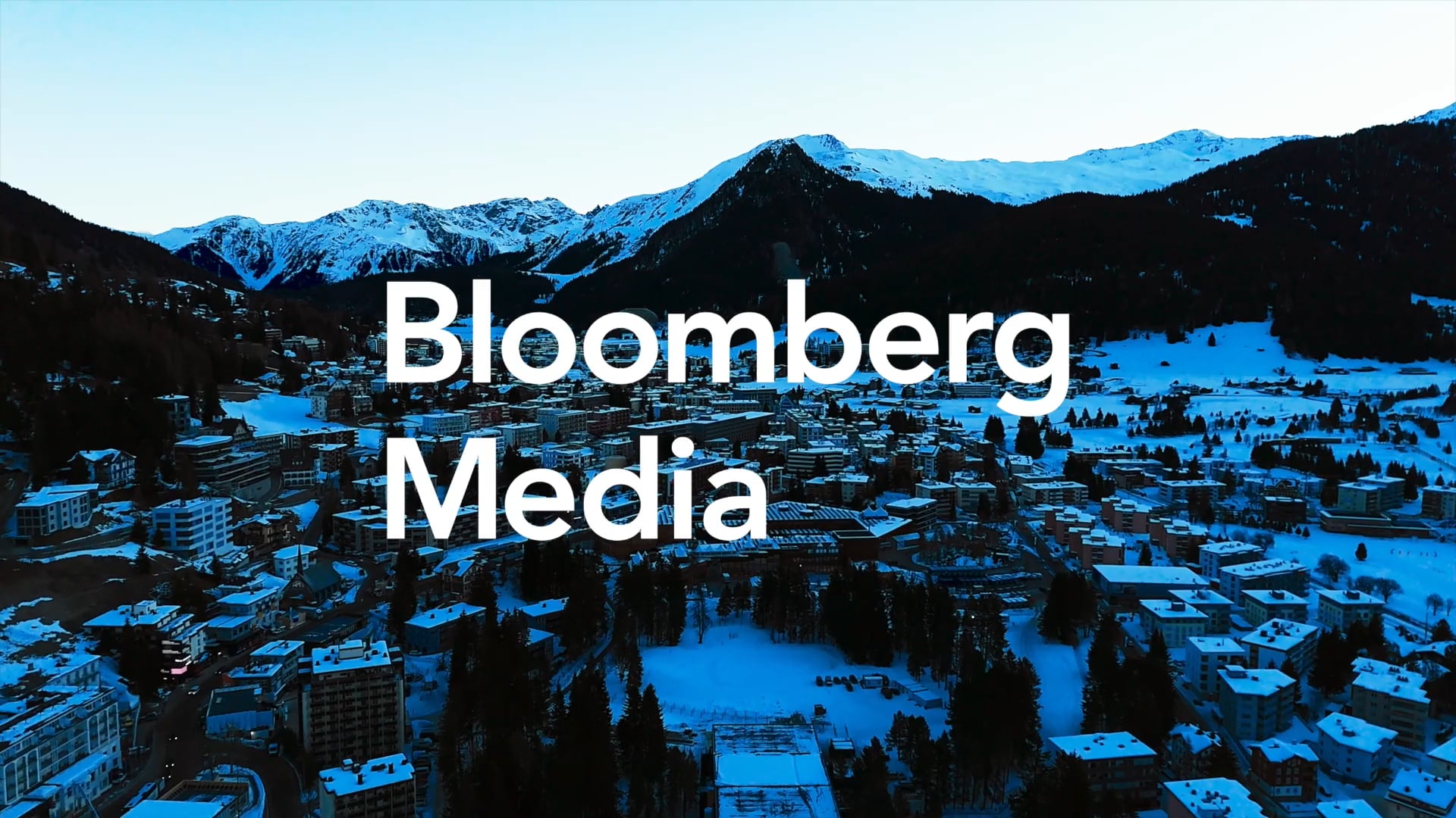 Bloomberg media text over snow cover mountain scene (Davos)